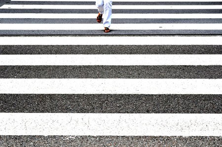 Women in sandals walk over a pedestrian crosswayの写真素材