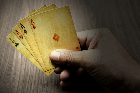 Poker cards in the right hand close up photoの写真素材