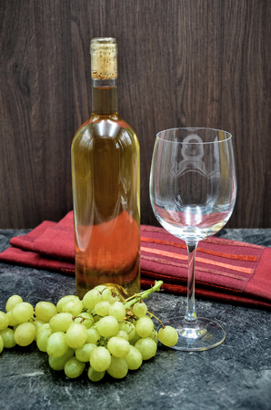 winebottle and glas with grape close upの写真素材