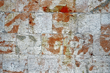 Stone wall near position red white colorの写真素材