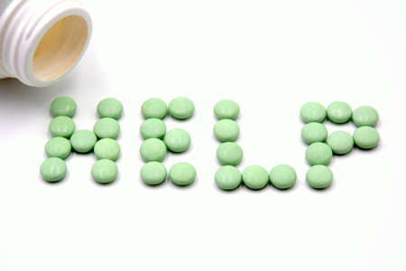 green pills close up on a white background photoの写真素材