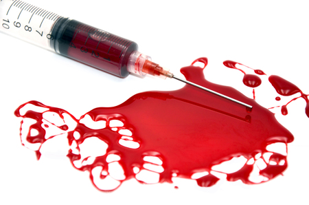 injection with blood on a white backgroundの写真素材