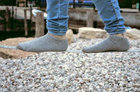 slacklining a man wih socks close up photoの写真素材