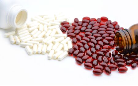 red and white pills on a white backgroundの写真素材