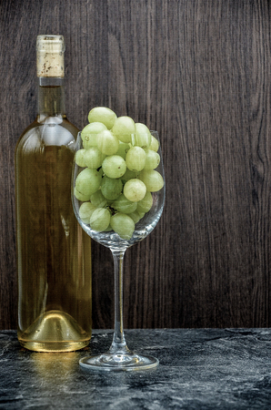 winebottle and glas with grape close upの写真素材