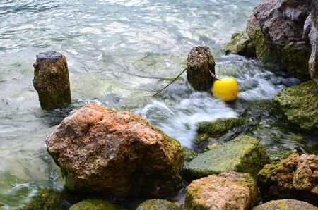 yelloww buoy boat in the water close up photoの写真素材