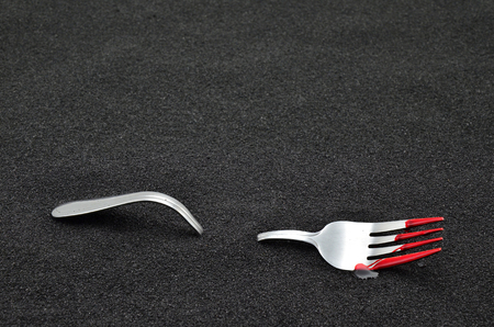 fork with blood on back sand close upの写真素材