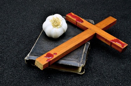Bible cross and a garlic close up photoの写真素材
