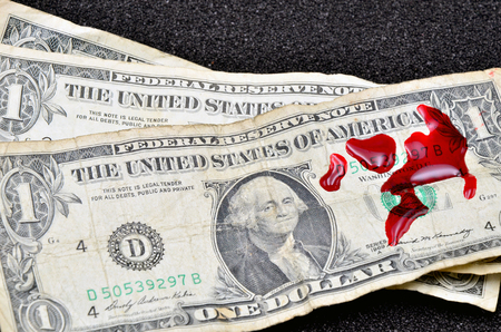 Dollar bill and blood close up photoの写真素材