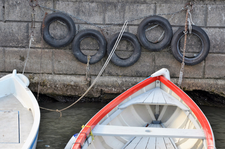 boat near the stone wall close up photoの写真素材