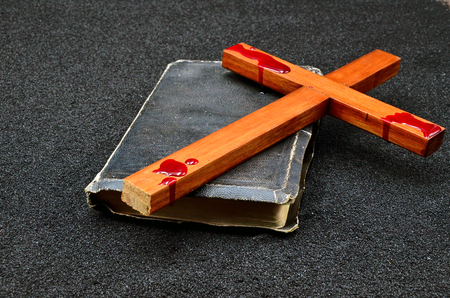 Bible cross on black sand close up photoの写真素材