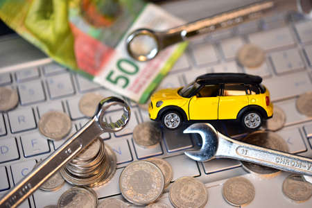 Car and money on the keyboard of a computer. The concept of buying or renting a car.の写真素材