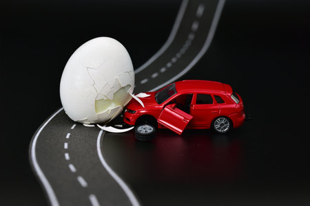 funny toy car accident with a chicken eggの写真素材