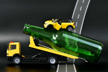 Broken car on a tow truck on the roadの写真素材