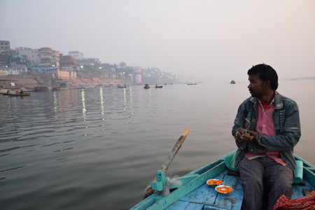 Indian boatman On His boat on river Ganga at sunrise, Varanasi, Uttar Pradesh, Indiaのeditorial素材