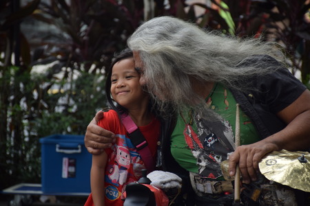 Malaysian man hugging his niece after playing music on the street in Kuala Lumpur, Malaysiaのeditorial素材