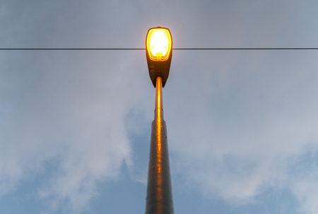 Old obsolete sodium vapor light emitting orange colored lightの写真素材