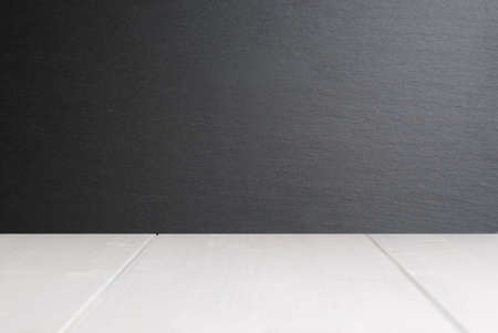 White wooden plank surface and black slate stone wall as blank template with copy spaceの写真素材