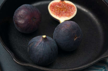 Fig fruits on the dark vintage iron pan