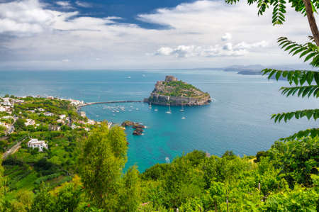 Aerial scenic view on Aragonese castle through foliage, Ischia, Italyの写真素材
