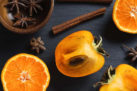 Top flat view: anise star, cinnamon sticks and persimmonの写真素材