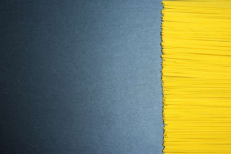 Top view: pasta or italian spaghetti on black slate background. Copy spaceの写真素材