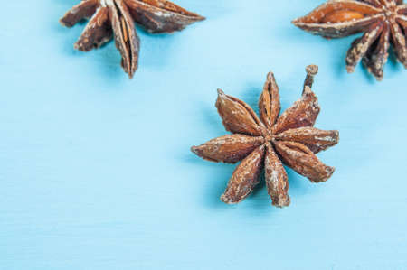 Anise star or badian on blue wooden background. Top viewの写真素材