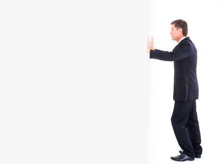 portrait of a business man pushing the wall. の写真素材