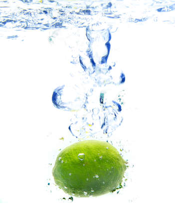 Lime dropped in a waterの写真素材