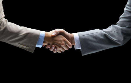 Handshake - Hand holding on black background 