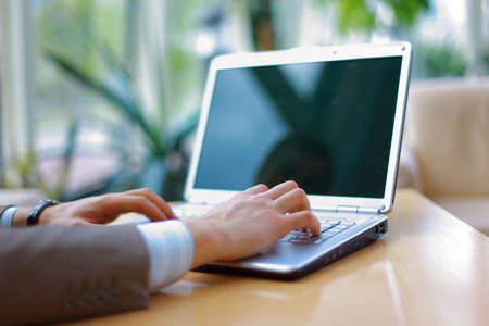 Person Typing on a modern laptop in an office 