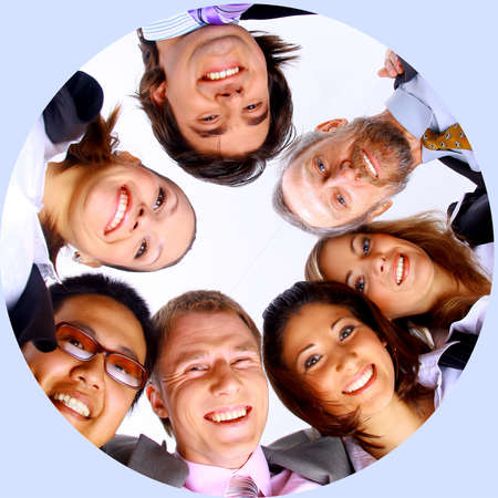 Group of business people standing in huddle, smiling, low angle viewの写真素材