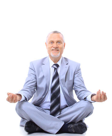 relaxed businessman meditating isolated on white の写真素材