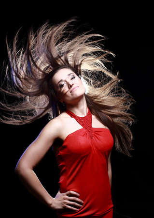 Young Woman with Windswept Hair on blue background の写真素材
