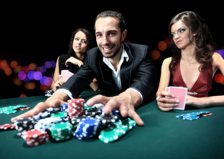 Poker player going all in pushing his chips forward