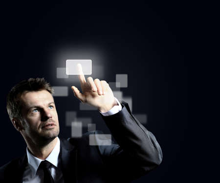 Business man pressing virtual buttonの写真素材