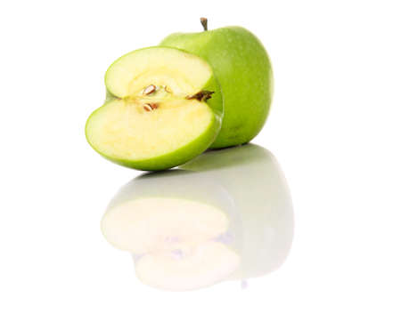 A green apple and its reflectionの写真素材