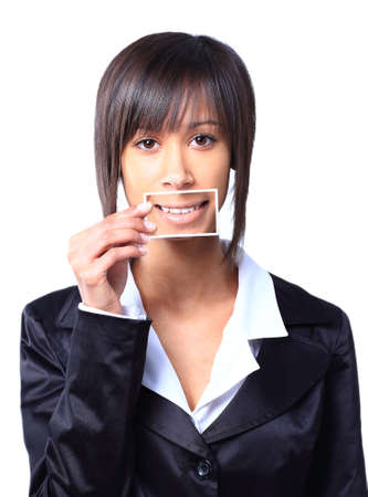 Girl holding a card with photo her smile in front of her mouthの写真素材
