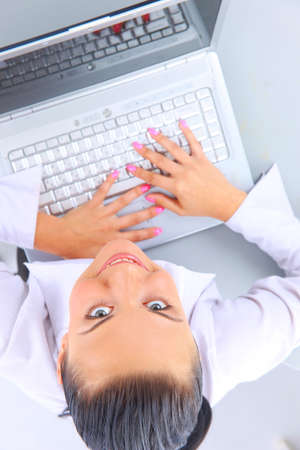 Young woman sitting on floor with a laptopの写真素材