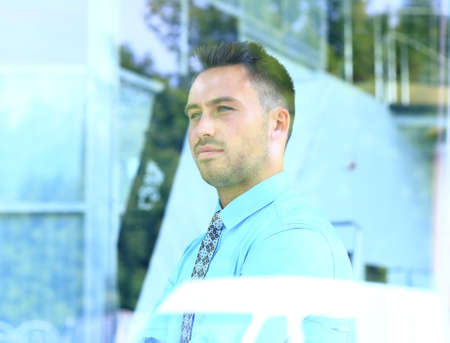 business man looking through windowの写真素材