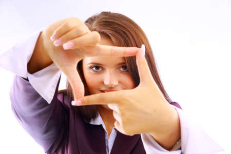 Beautiful young woman creating a frame with her fingers

の写真素材