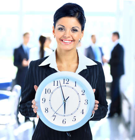 Young attractive business woman  holding clock の写真素材