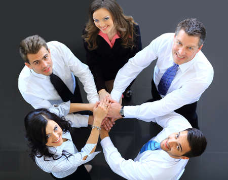 Top view of business people with their hands together in a circle