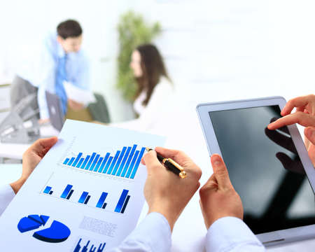 Business work-group analyzing financial data in office