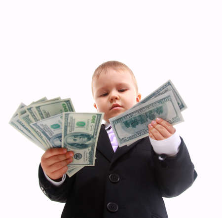 Cute little boy holds a fan of banknotesの写真素材