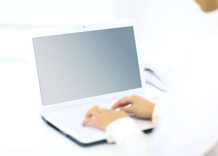 Person Typing on a modern laptop in an office