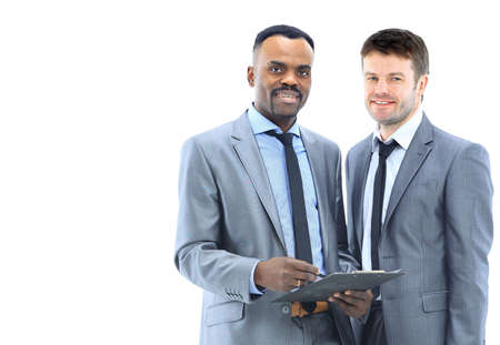 Diverse businesspeople conversing and taking notesの写真素材