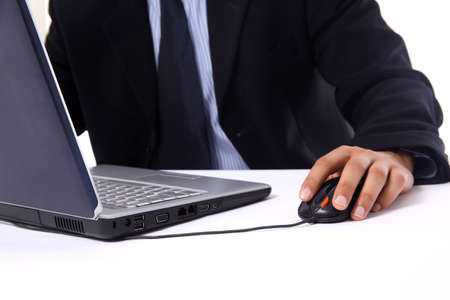 businessman sitting by desk at office working on the laptop の写真素材