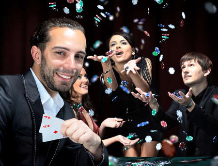 Poker players sitting around a table at a casinoの写真素材