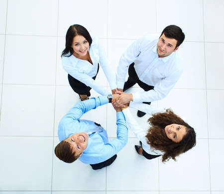 Top view of business people with their hands together in a circle